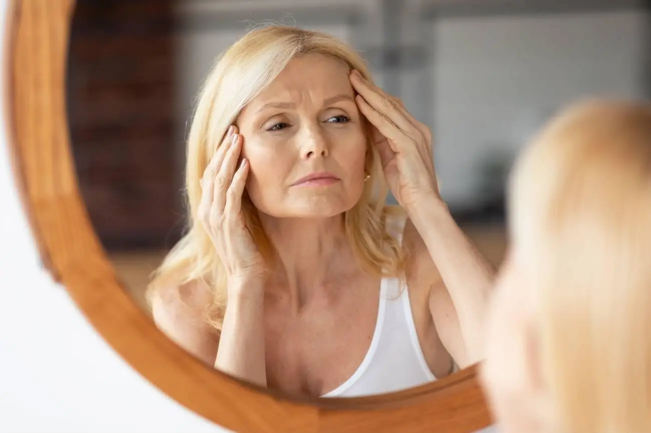 An elegant woman with healthy skin representing age-appropriate treatments for fine lines and wrinkles in your 30s, 40s, and 50s.