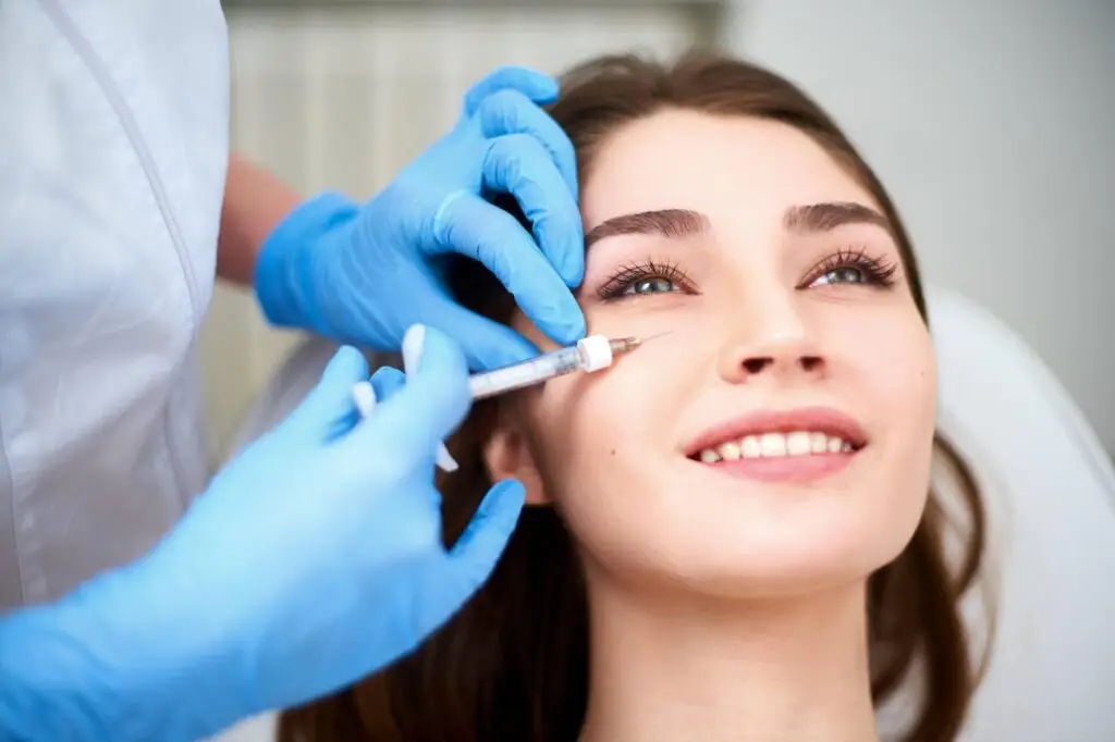 A woman with bright and refreshed eyes, representing the reduction of dark circles and hollows through professional under-eye rejuvenation.