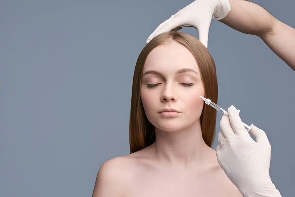 A woman with a glowing, even skin tone showcasing the rejuvenating effects of PRP Microneedling for patients in Roswell, GA.