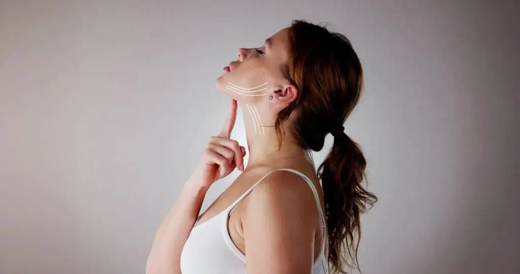 A side profile of a woman with a sleek, defined jawline showcasing the non-surgical results of a Nefertiti Neck Lift.