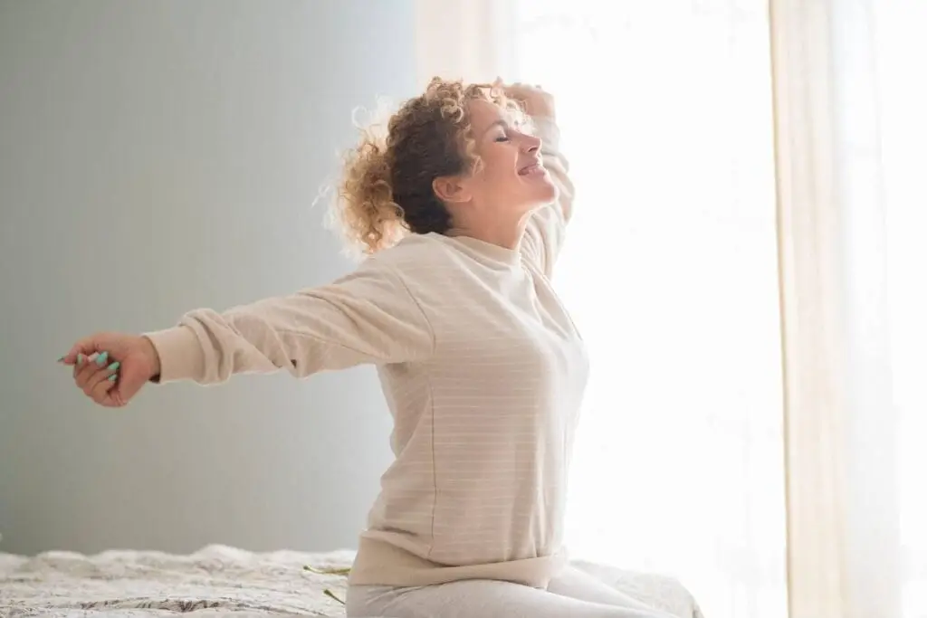 A woman with glowing, healthy skin representing the positive impact of Hormone Replacement Therapy on long-term skin vitality.